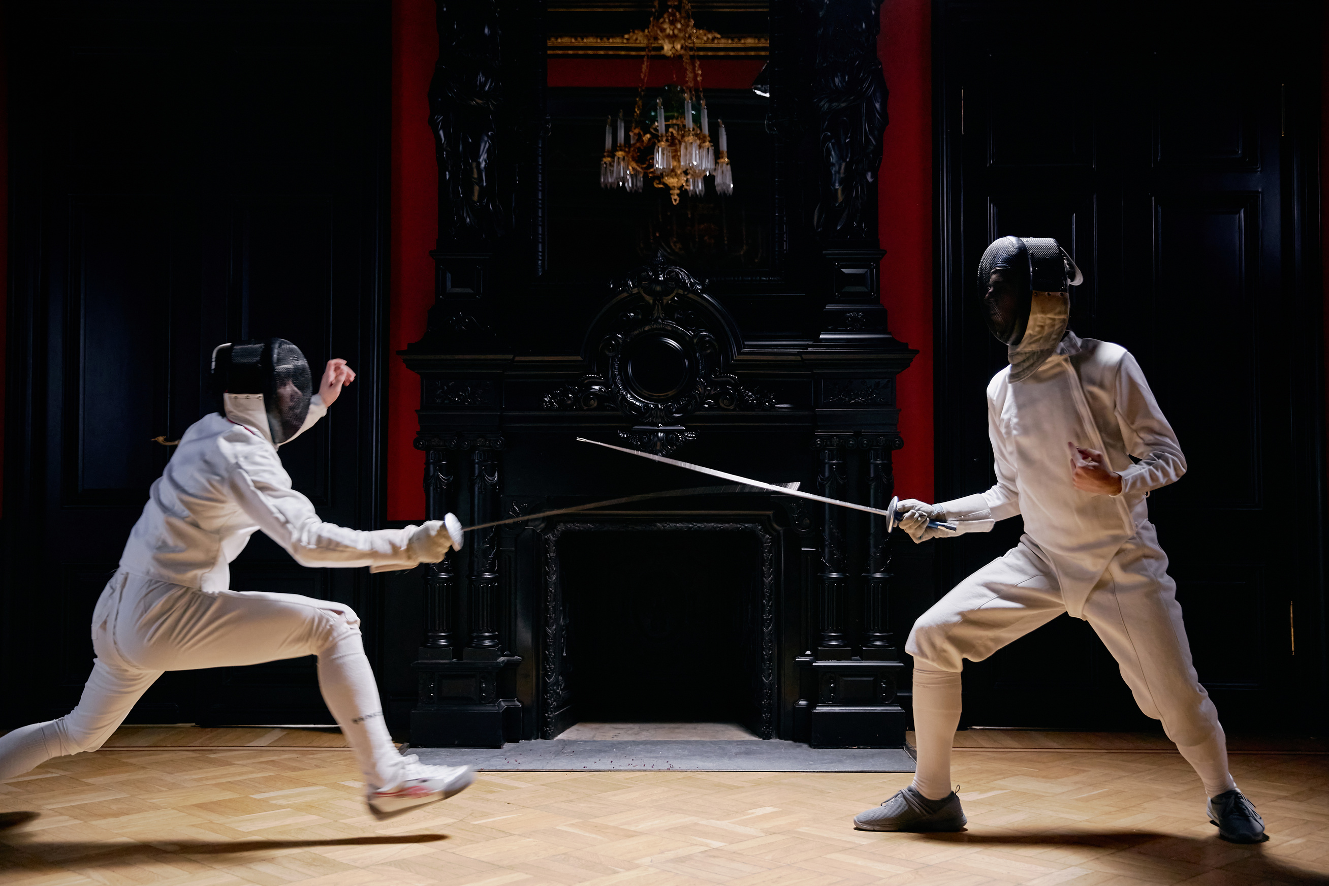 Two Men In Fencing Suit Practicing With Sword